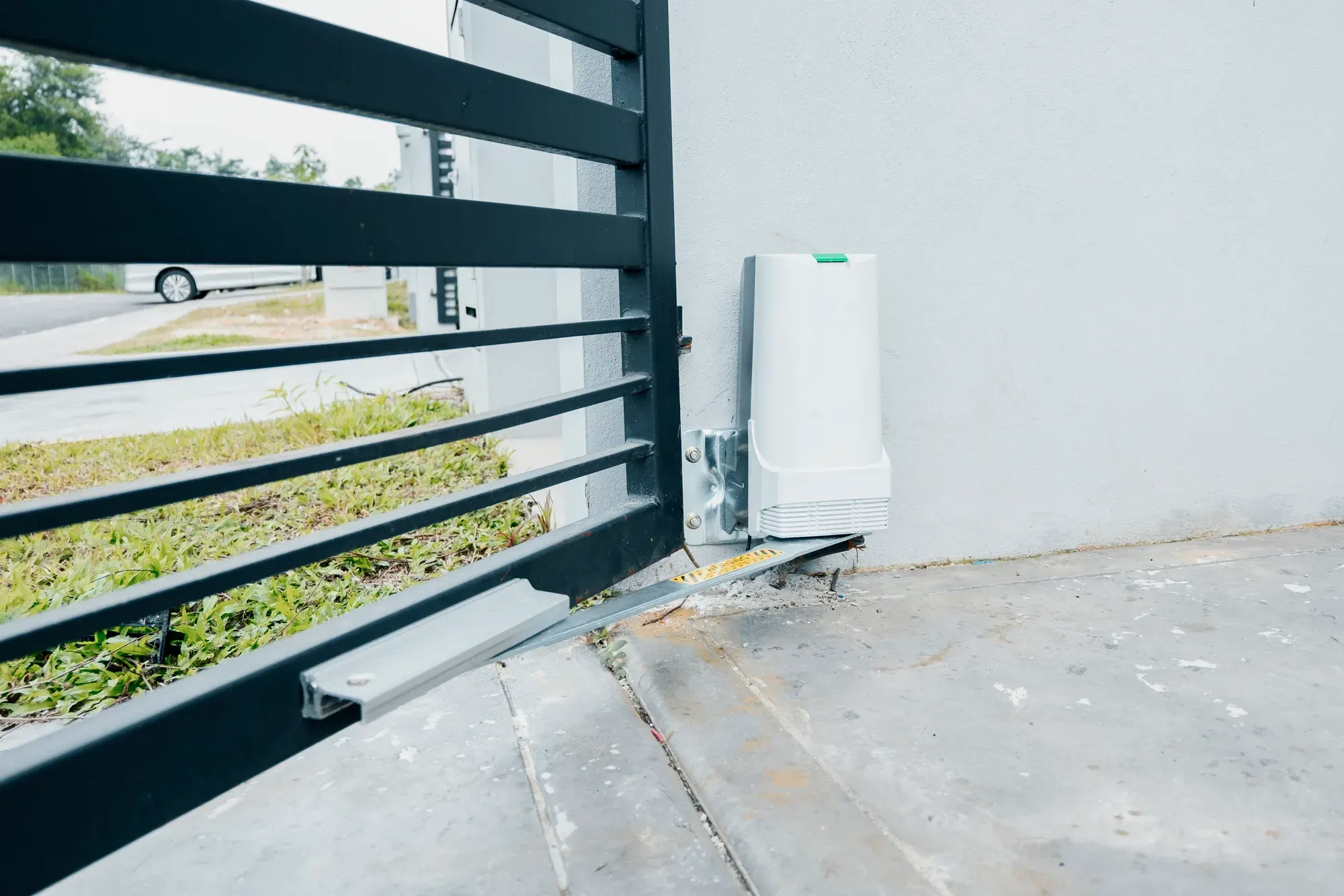 Gate motor fitted to a black sliding gate